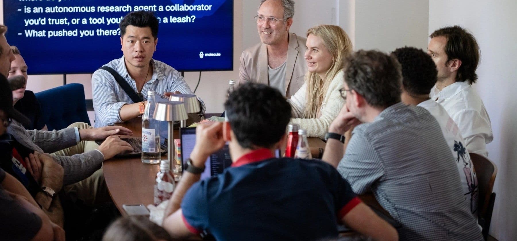 Researchers around a table at a DeSci.Berlin 2026 workshop, listening to the speaker.